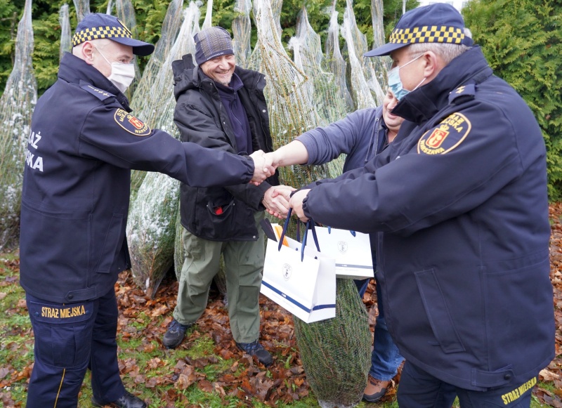 Wspólne zdjęcie leśników i&nbsp;strażników przy dostarczonych choinkach.